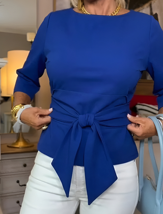 Woman wearing a tie waist flattering top with an adjustable soft waist tie