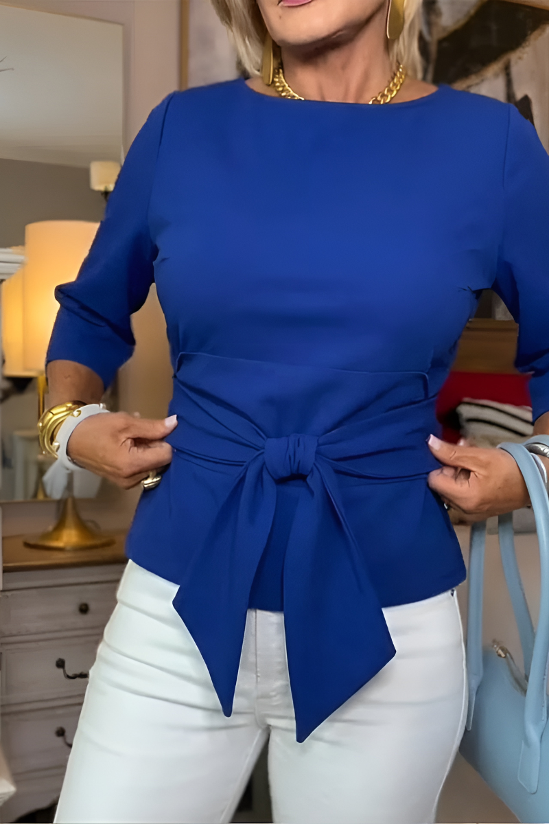 Woman wearing a tie waist flattering top with an adjustable soft waist tie