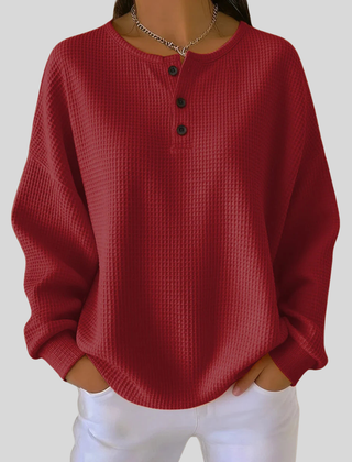 Relaxed-fit waffle-knit henley sweatshirt with button neckline, shown in several colours