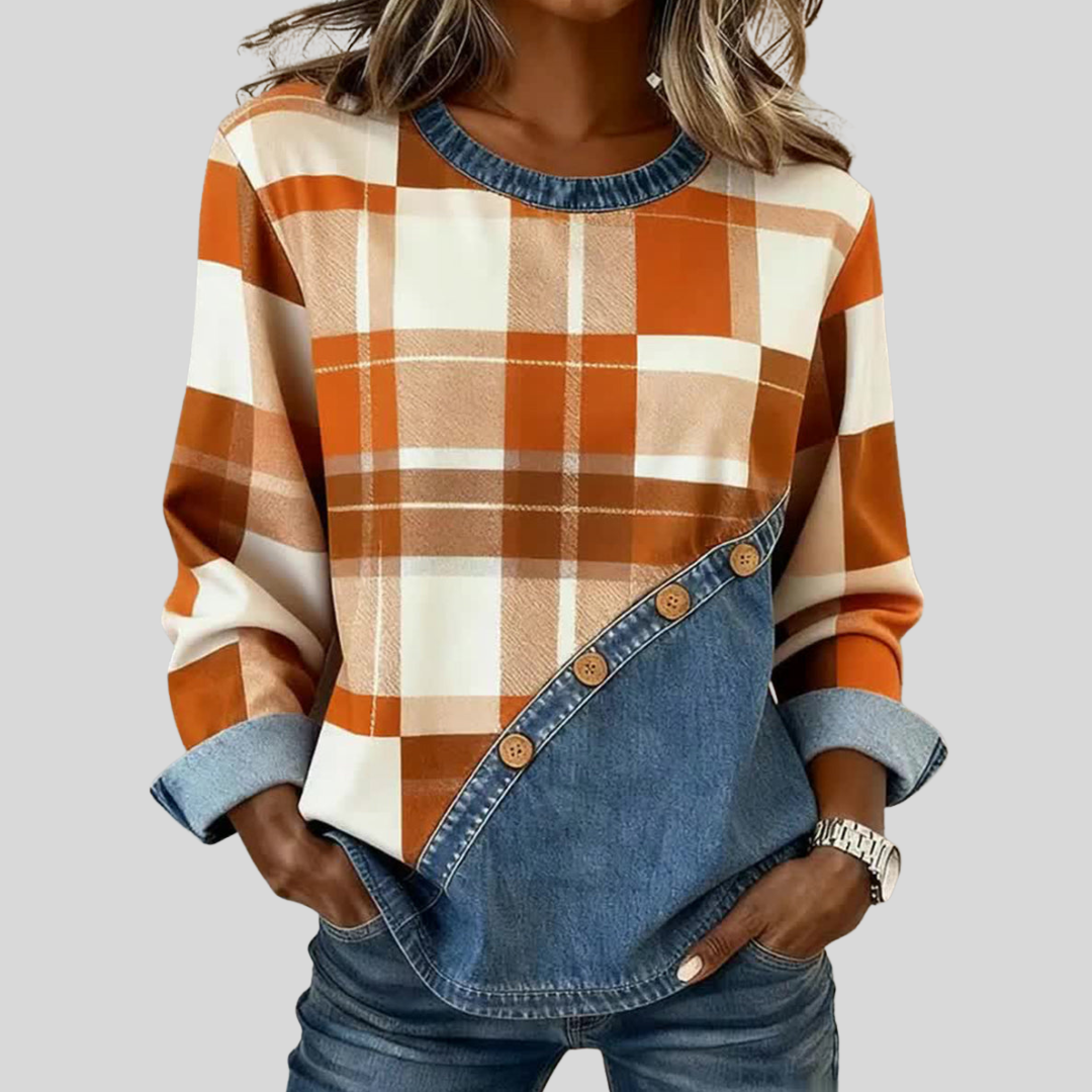 Warm-toned plaid patchwork pullover top with denim-style panel, crew neckline and wooden buttons
