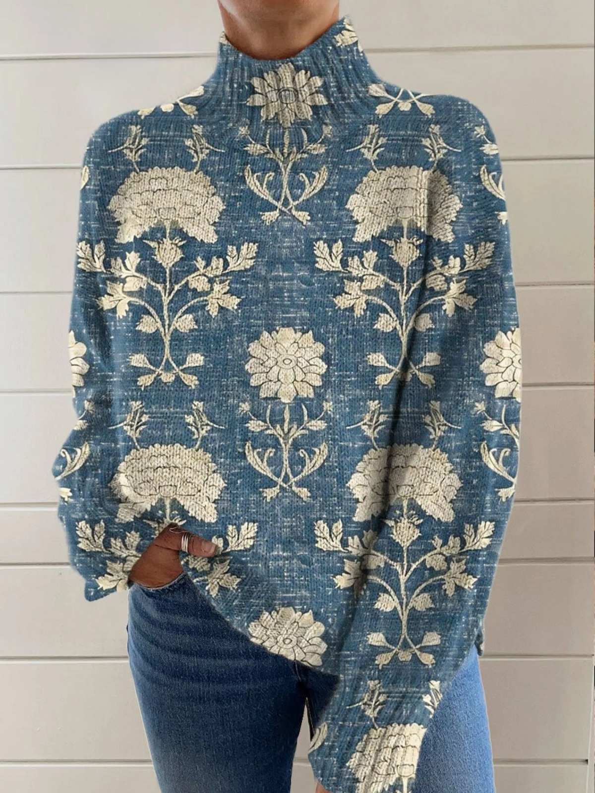 Blue floral turtleneck knit sweater with ribbed cuffs and relaxed fit