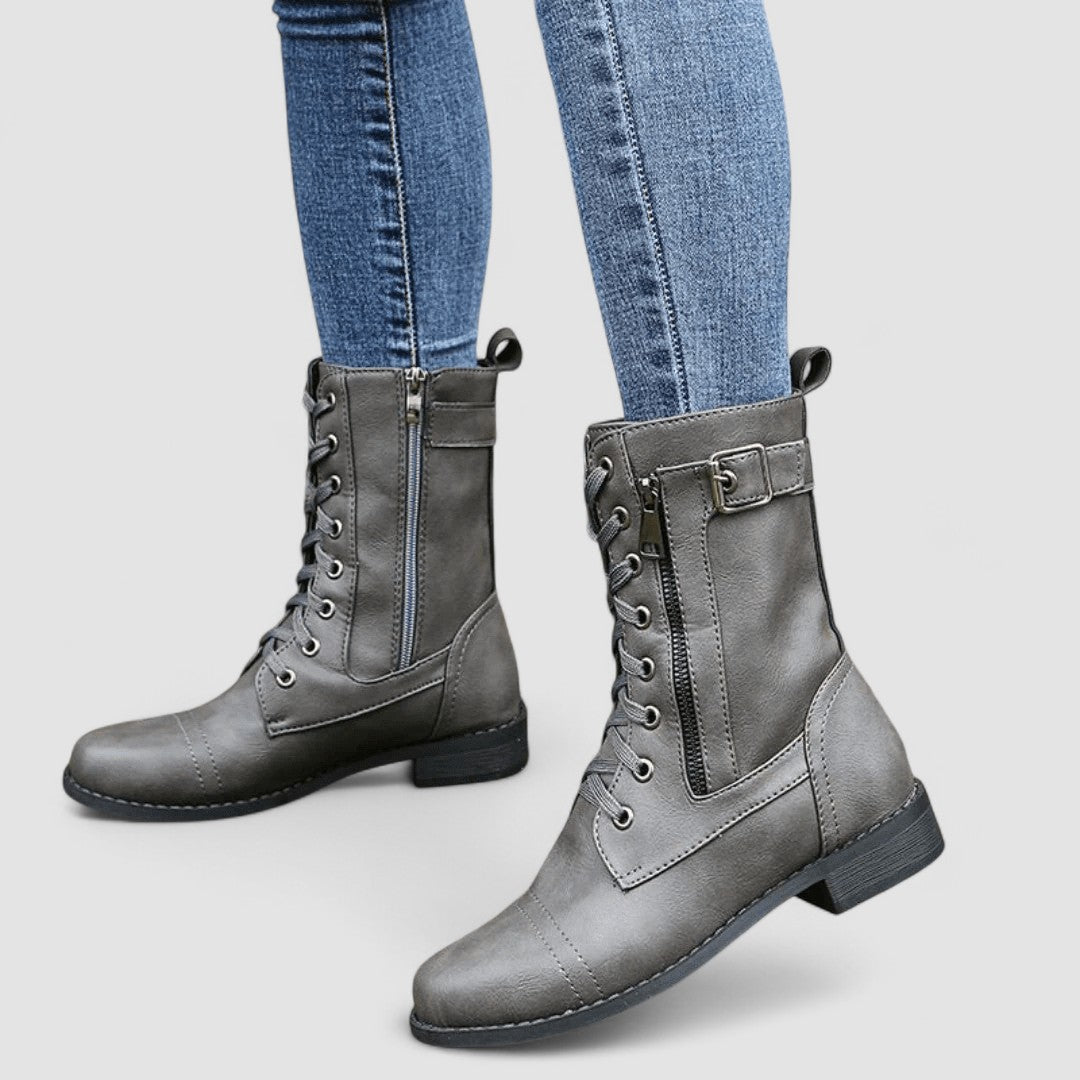 Buckled mid-calf combat boots with lace-up front and low block heel in brown, black and grey
