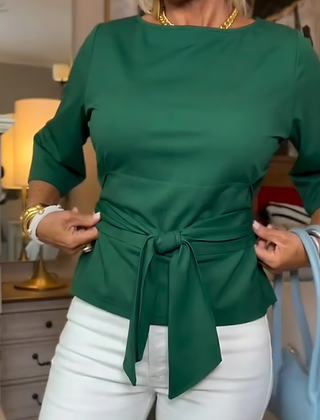 Woman wearing a tie waist flattering top with an adjustable soft waist tie
