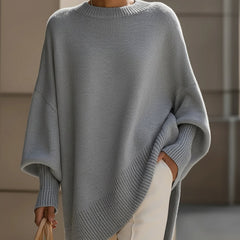 Oversized draped sweater with wide rounded neckline, ribbed cuffs and asymmetrical hem
