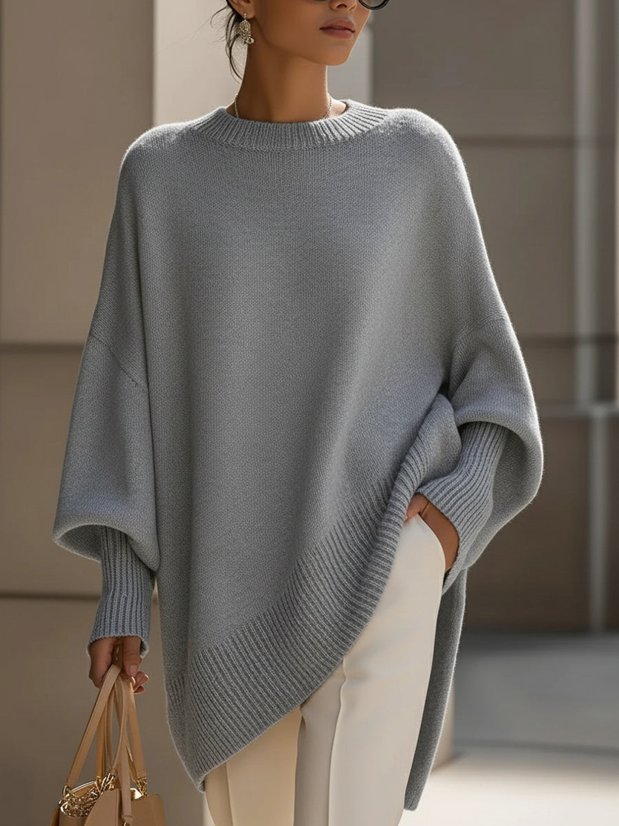 Oversized draped sweater with wide rounded neckline, ribbed cuffs and asymmetrical hem