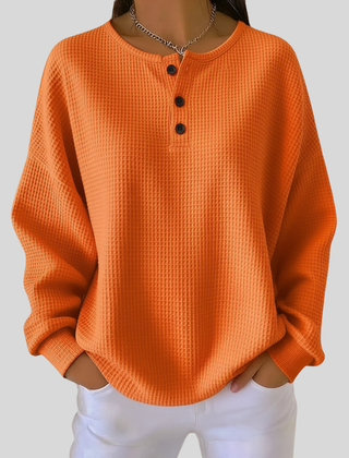 Relaxed-fit waffle-knit henley sweatshirt with button neckline, shown in several colours