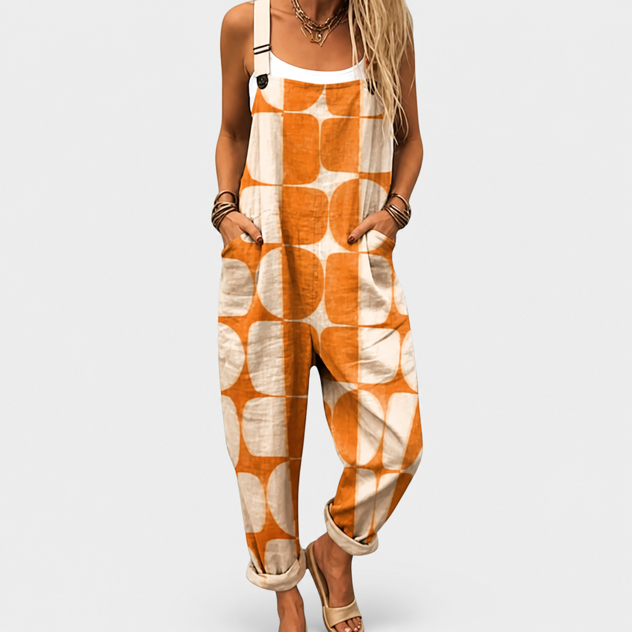 Woman wearing a printed wide-leg jumpsuit with adjustable straps