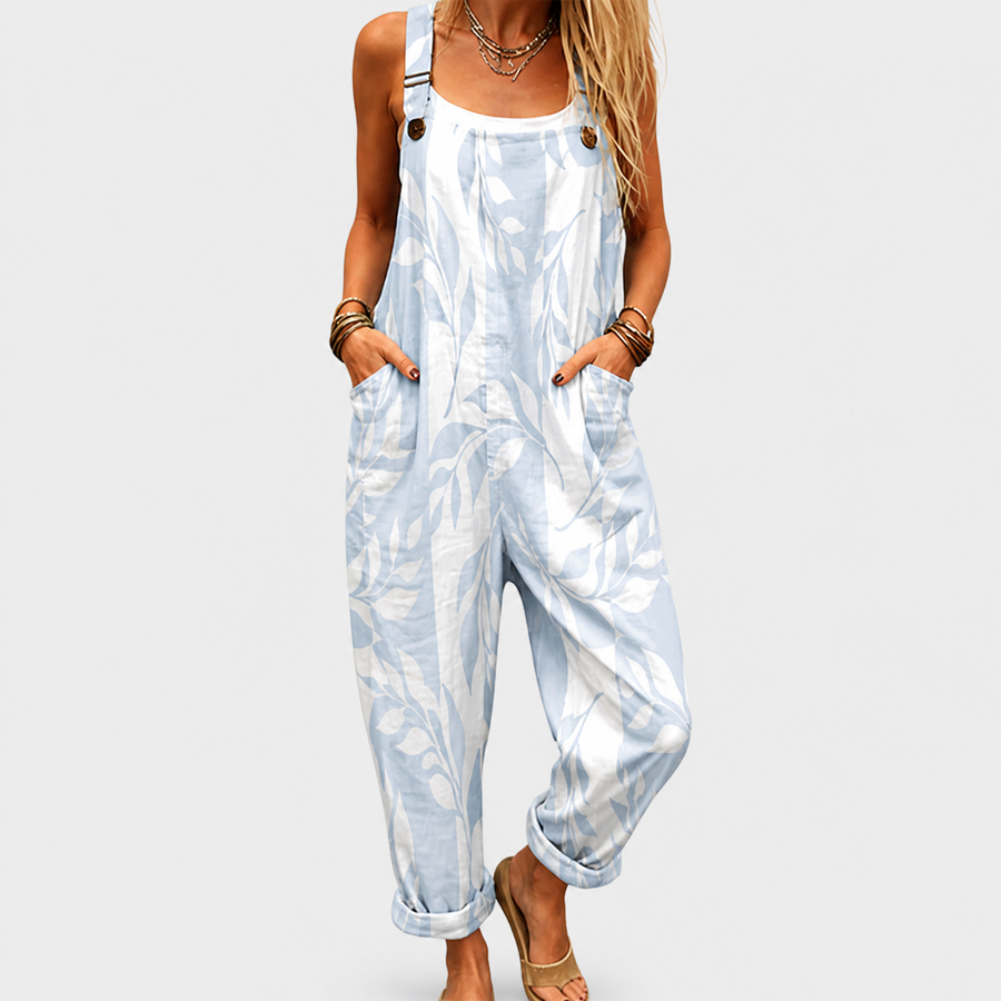 Woman wearing a printed wide-leg jumpsuit with adjustable straps and a relaxed, flattering fit