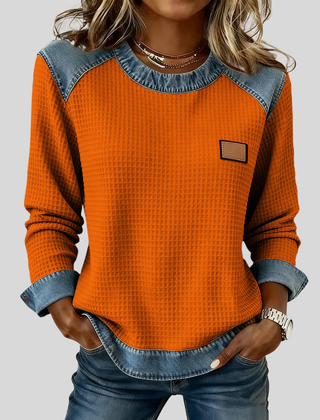 Waffle-knit sweatshirt with denim-inspired trim and a small chest patch, shown in several colours