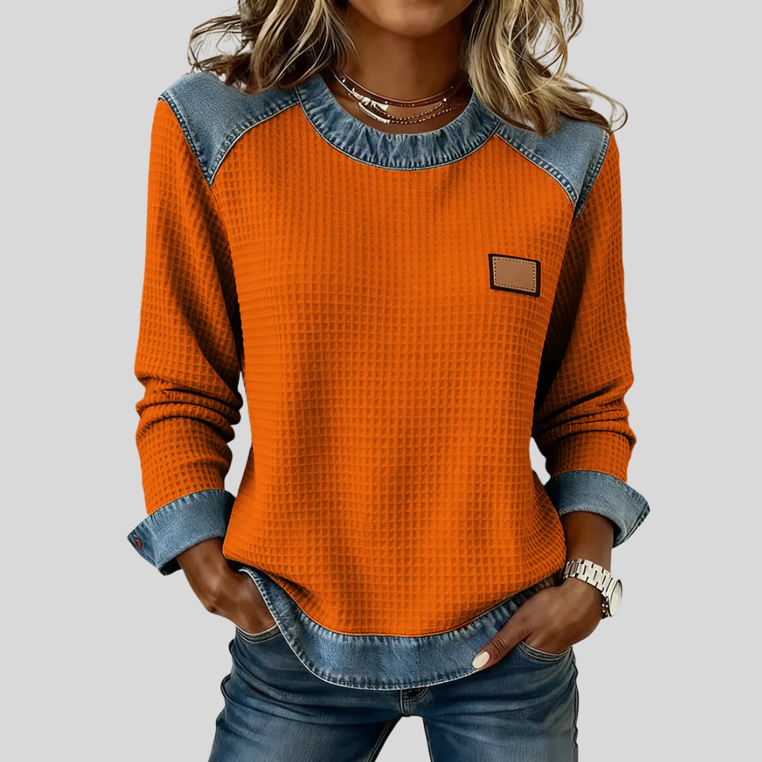 Waffle-knit sweatshirt with denim-inspired trim and a small chest patch, shown in several colours