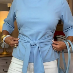 Woman wearing a tie waist flattering top with an adjustable soft waist tie