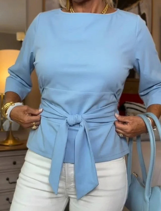 Woman wearing a tie waist flattering top with an adjustable soft waist tie