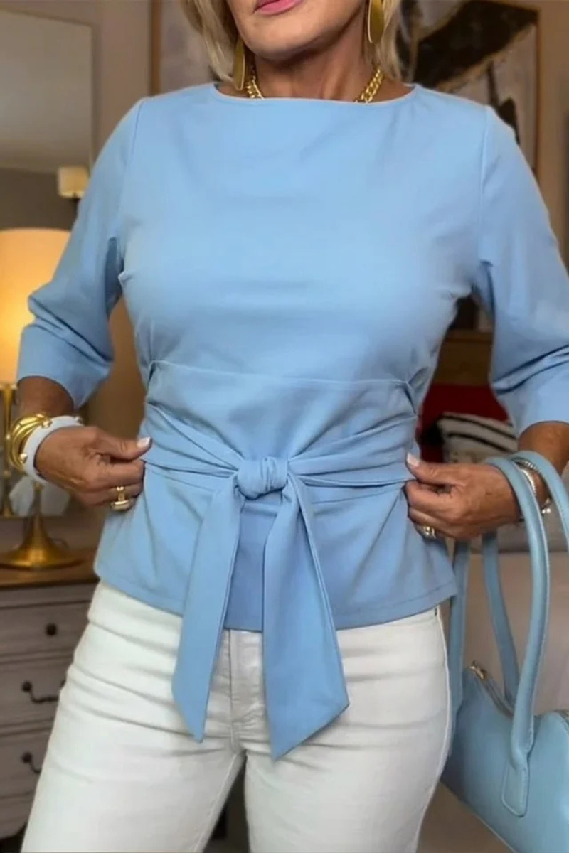 Woman wearing a tie waist flattering top with an adjustable soft waist tie