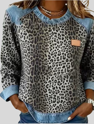 Leopard print sweater with contrast denim collar, cuffs, and hem in grey and red