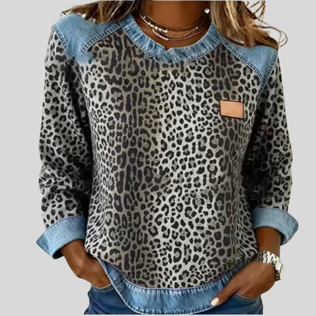 Leopard print sweater with contrast denim collar, cuffs, and hem in grey and red