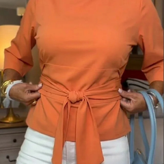 Woman wearing a tie waist flattering top with an adjustable soft waist tie
