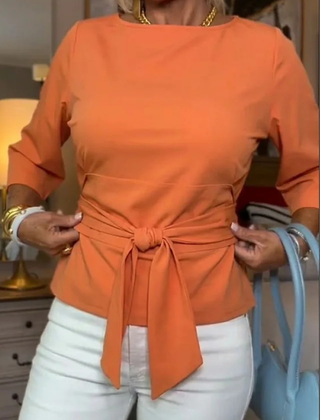 Woman wearing a tie waist flattering top with an adjustable soft waist tie