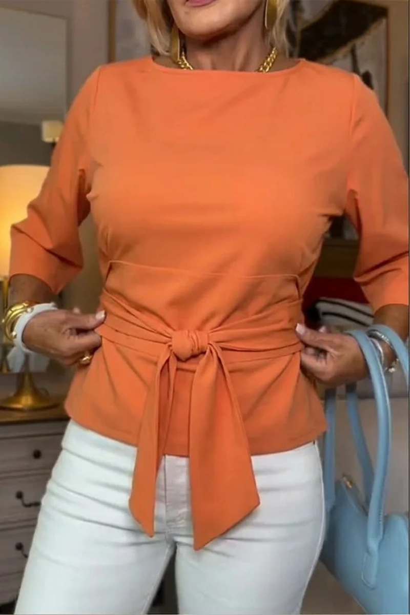 Woman wearing a tie waist flattering top with an adjustable soft waist tie