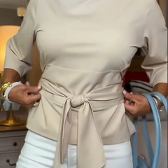 Woman wearing a tie waist flattering top with an adjustable soft waist tie