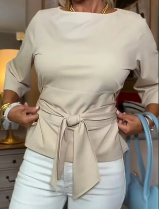 Woman wearing a tie waist flattering top with an adjustable soft waist tie