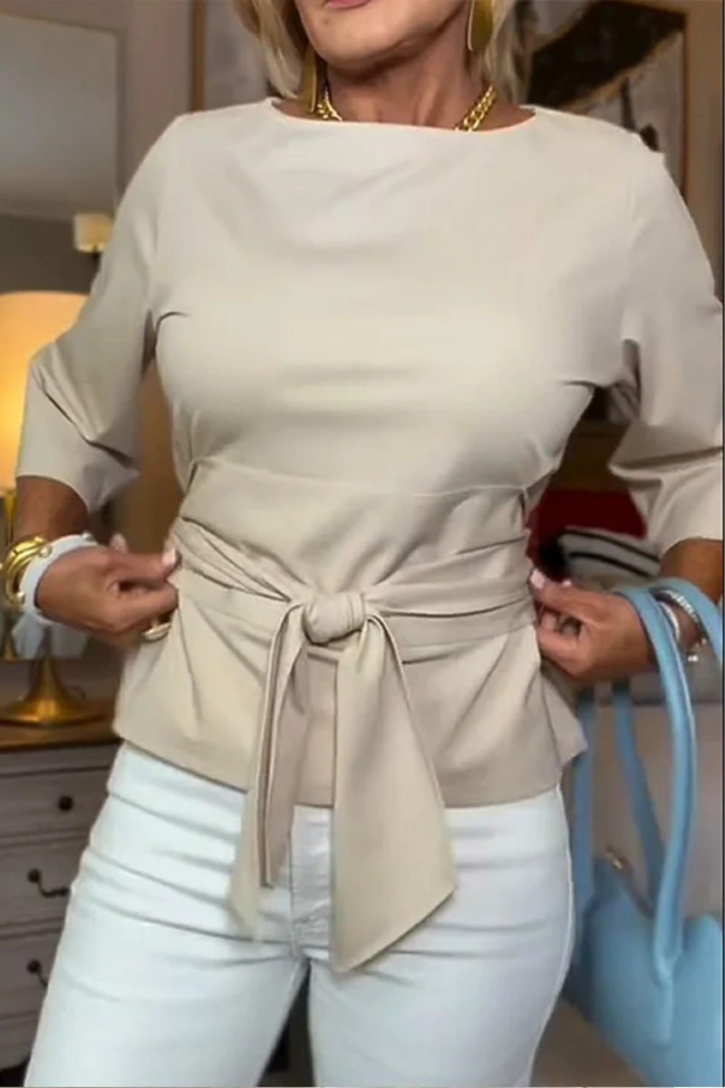 Woman wearing a tie waist flattering top with an adjustable soft waist tie