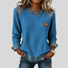Waffle-knit sweatshirt with denim-inspired trim and a small chest patch, shown in several colours