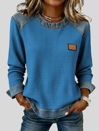 Waffle-knit sweatshirt with denim-inspired trim and a small chest patch, shown in several colours