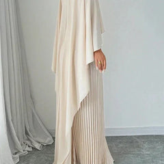 Elegant pleated cape maxi dress with flowing overlay and floor-length skirt
