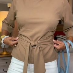 Woman wearing a tie waist flattering top with an adjustable soft waist tie