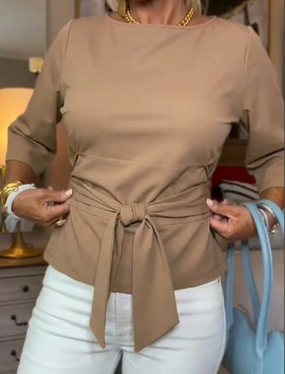 Woman wearing a tie waist flattering top with an adjustable soft waist tie