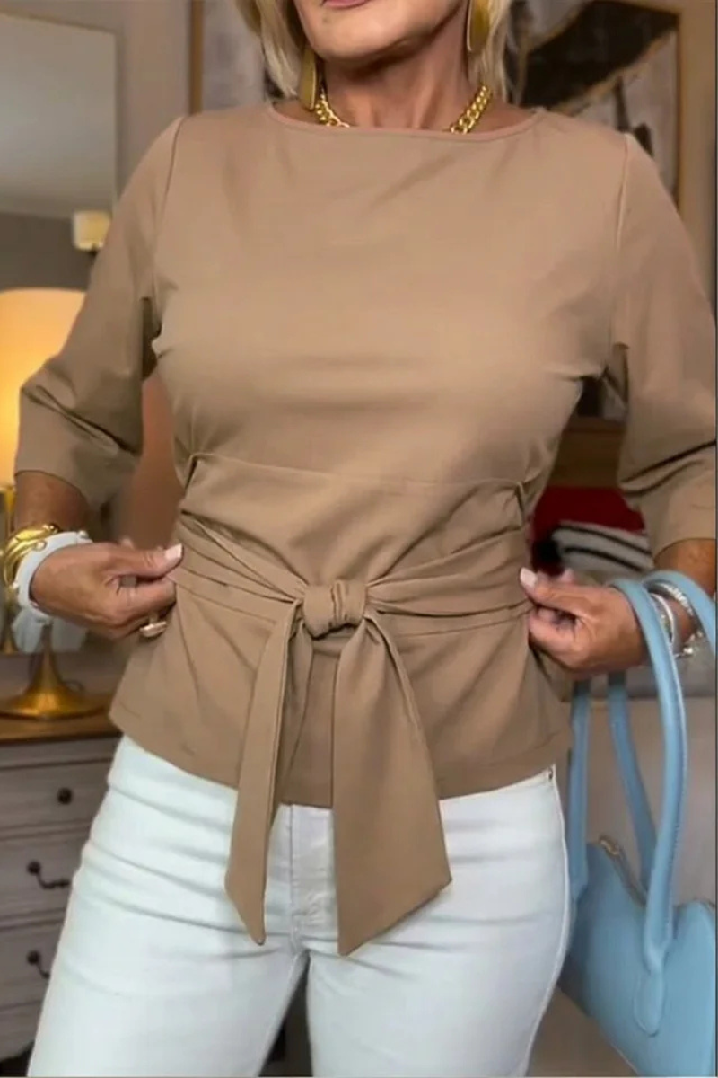 Woman wearing a tie waist flattering top with an adjustable soft waist tie