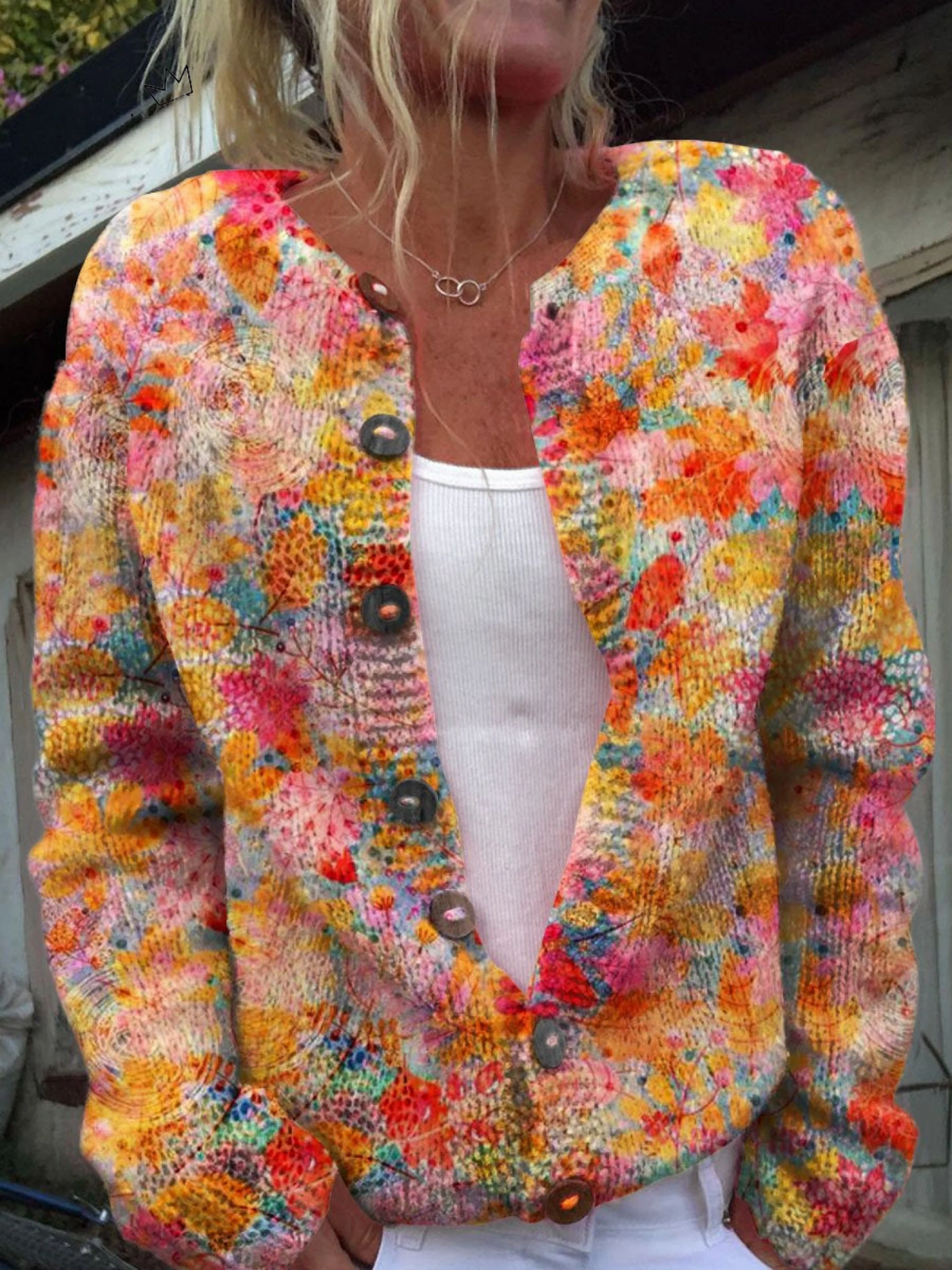 Women's open-front knit cardigan in a vibrant floral print with dark buttons