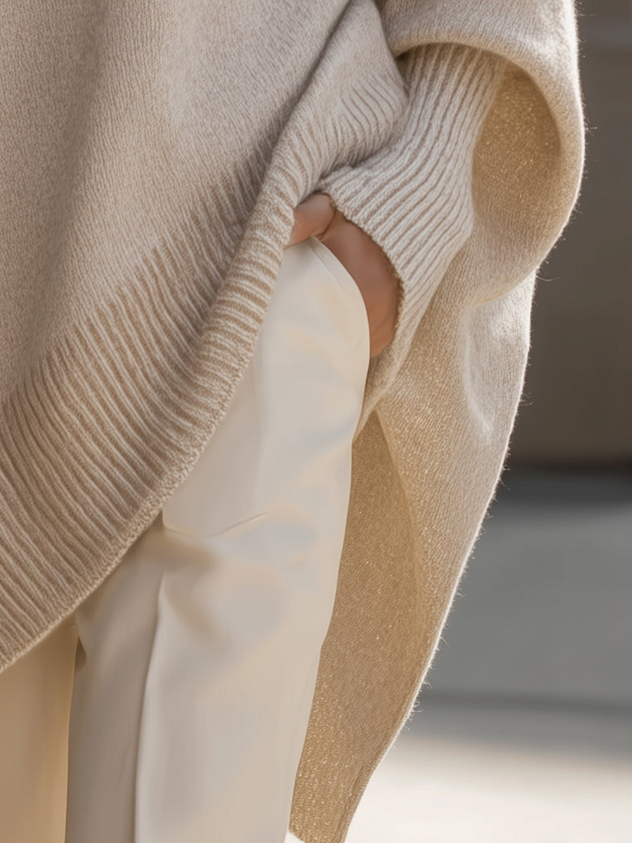 Oversized poncho-style sweater with round neckline, ribbed cuffs and hem in a neutral tone