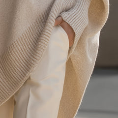 Oversized draped sweater with wide rounded neckline, ribbed cuffs and asymmetrical hem
