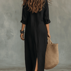Woman wearing a black button-front bohemian shirt maxi dress with a flowy silhouette