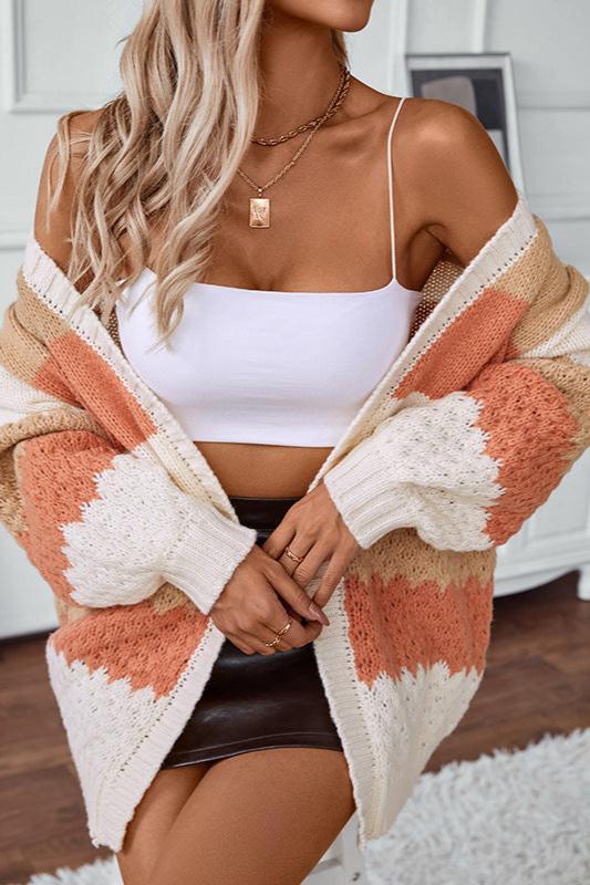 Woman wearing an oversized slouchy open-front knit cardigan with long sleeves