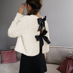 Beige textured sequin cropped jacket with oversized velvet bow detailing