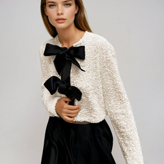 Beige textured sequin cropped jacket with oversized velvet bow detailing