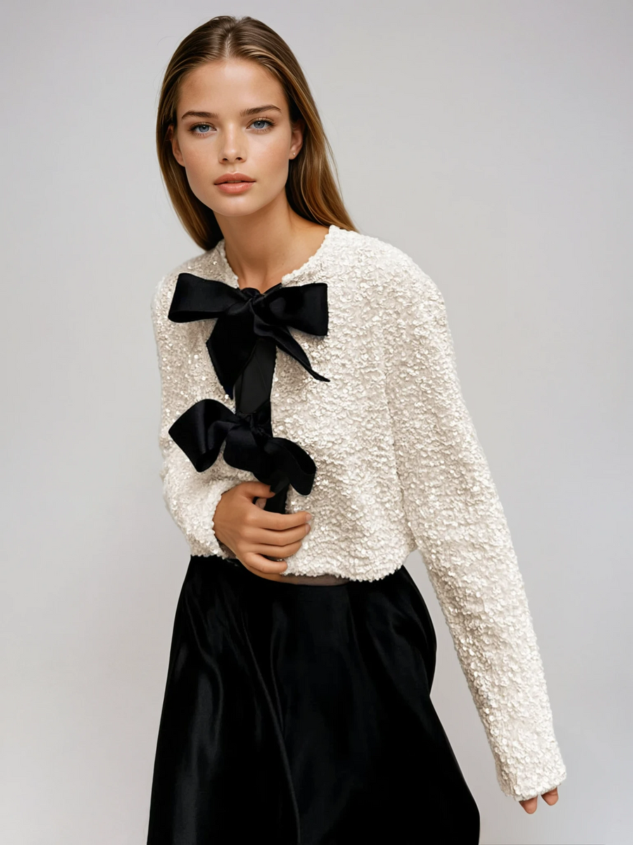 Beige textured sequin cropped jacket with oversized velvet bow detailing