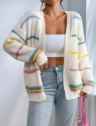 Woman wearing an oversized open-front knit cardigan with long sleeves in a soft tone