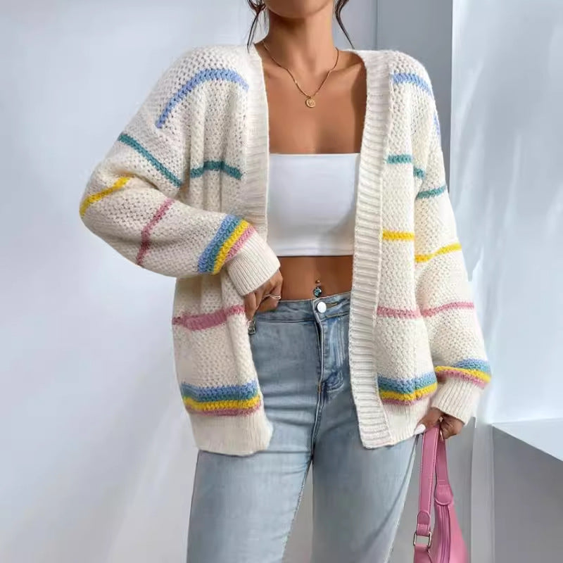Woman wearing an oversized open-front knit cardigan with long sleeves in a soft tone