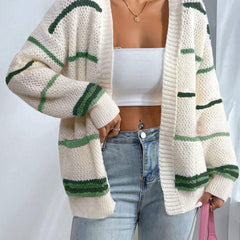 Woman wearing an oversized open-front knit cardigan with long sleeves in a soft tone
