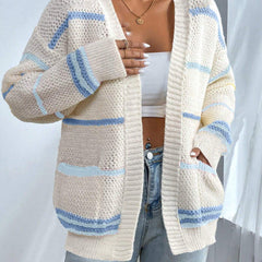 Woman wearing an oversized open-front knit cardigan with long sleeves in a soft tone