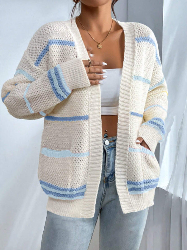 Woman wearing an oversized open-front knit cardigan with long sleeves in a soft tone