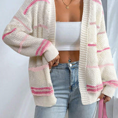 Woman wearing an oversized open-front knit cardigan with long sleeves in a soft tone