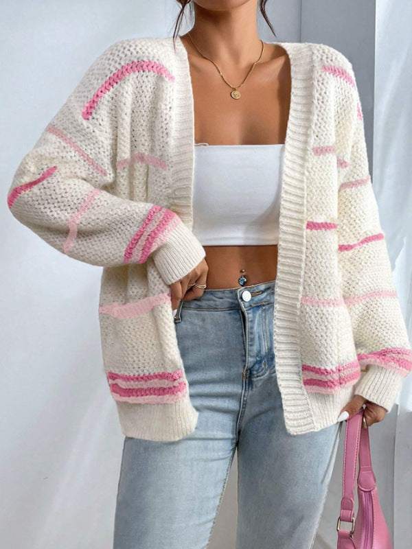Woman wearing an oversized open-front knit cardigan with long sleeves in a soft tone