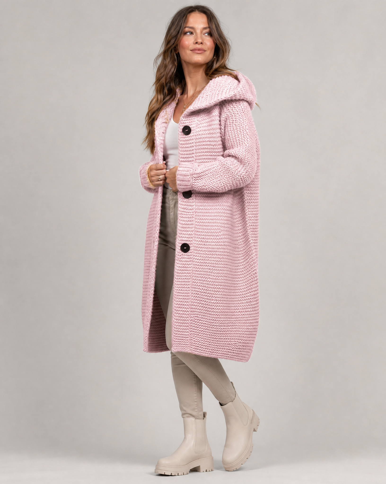 Women's hooded oversized chunky knit cardigan with large buttons in a soft neutral shade
