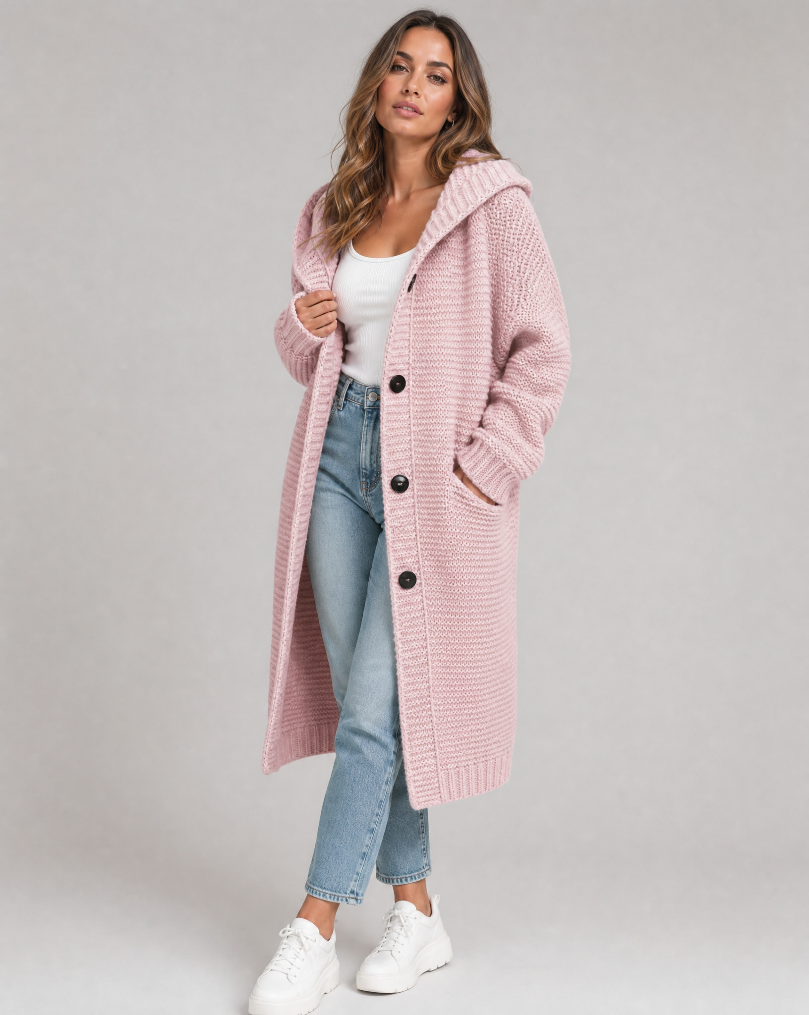 Women's hooded oversized chunky knit cardigan with large buttons in a soft neutral shade