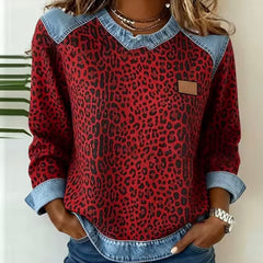 Leopard print sweater with contrast denim collar, cuffs, and hem in grey and red