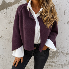 Woman wearing a soft cropped faux cashmere jacket with a snap front closure